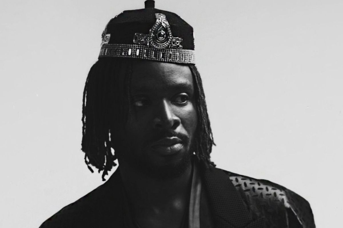 A black and white image of Fuse ODG wearing a crown and a robe.