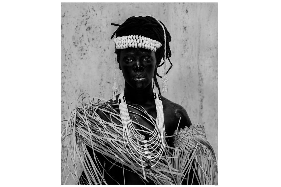 A black and white photo of a woman in traditional garb.