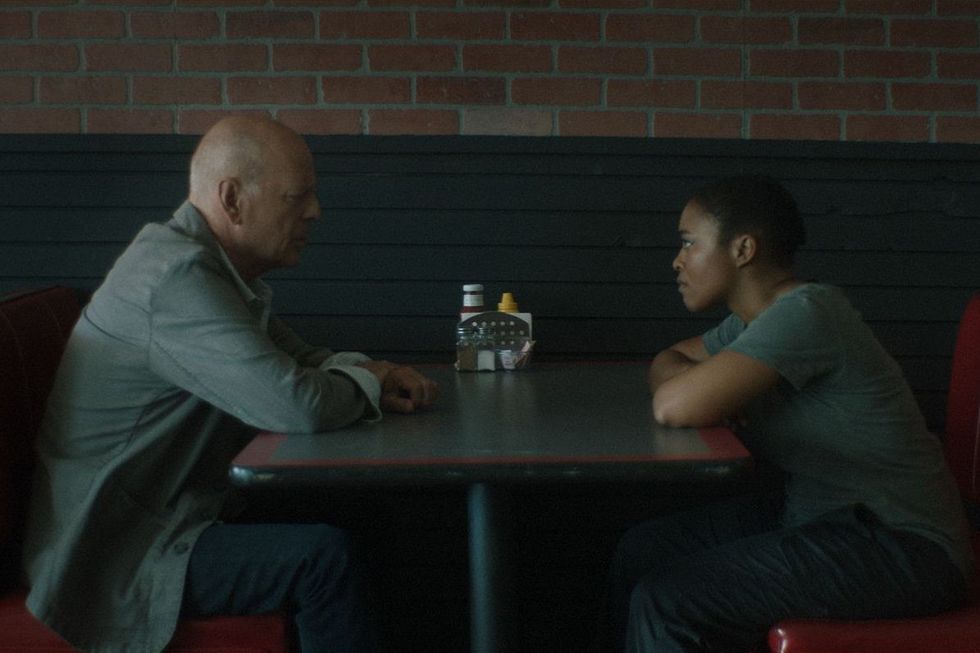 A film still of Nomzamo Mbatha and Bruce Willis from the movie, Assassin.