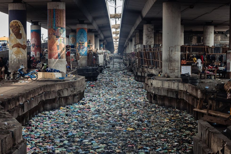 A general view of a clogged up canal filled with styrofoam and single use plastic at Obalende in Lagos on January 23, 2024.