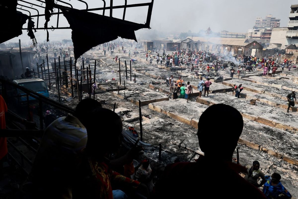 A general view of people trying to salvage items from the burned down secondhand clothing market at Kantamanto in Accra, Ghana, on January 2, 2025. The fire at the Kantamanto market began in the early morning hours, destroying a large part of the area and displacing thousands of traders.