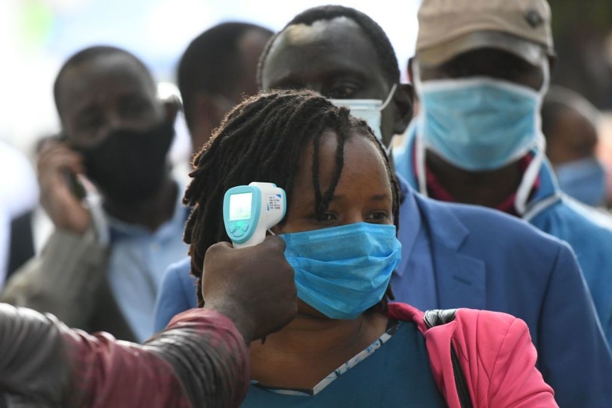 A Kenyan commuter is tested for the coronavirus while waiting in the queue. 