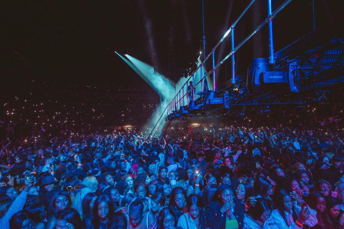 A large crowd of audience members for Wizkid's 2019 concert in London's O2 Arena. 