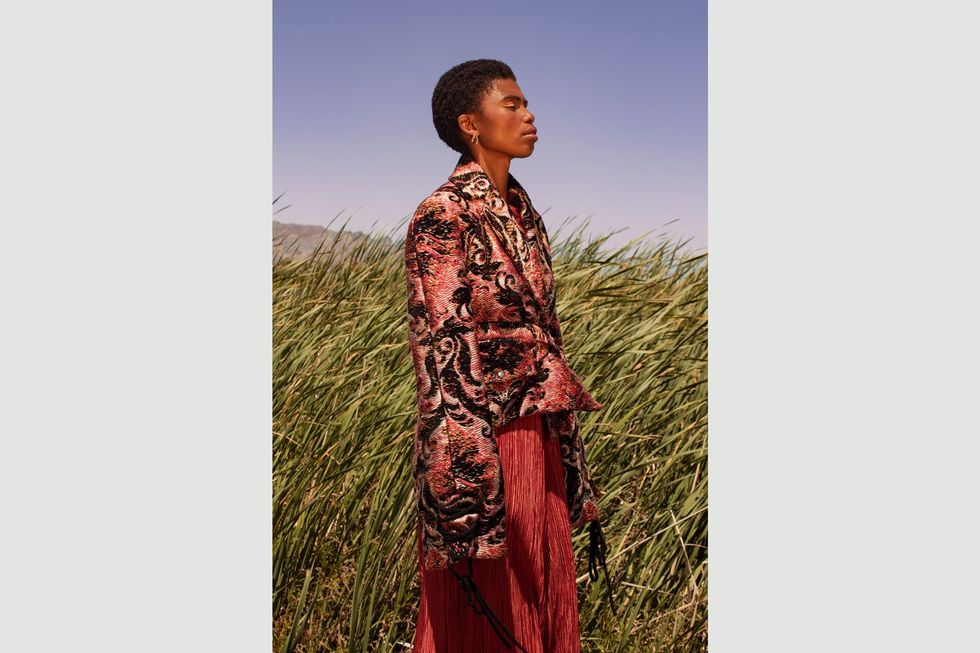 A look from Michael Ludwig\u2019s graduate collection: an embroidered jacket in red and black with a Damascus motif.