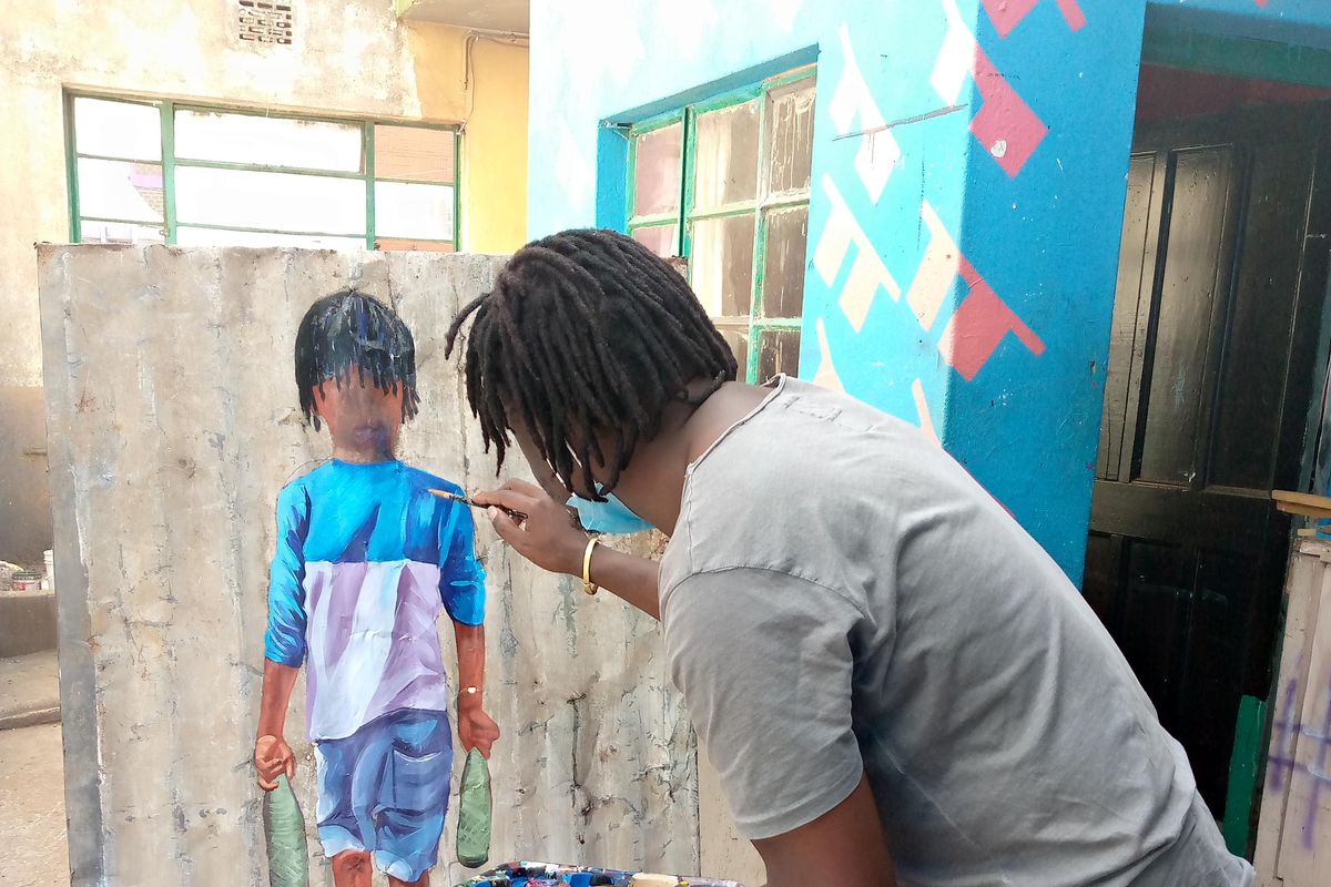 A man paints a picture of a child holding two empty bottles