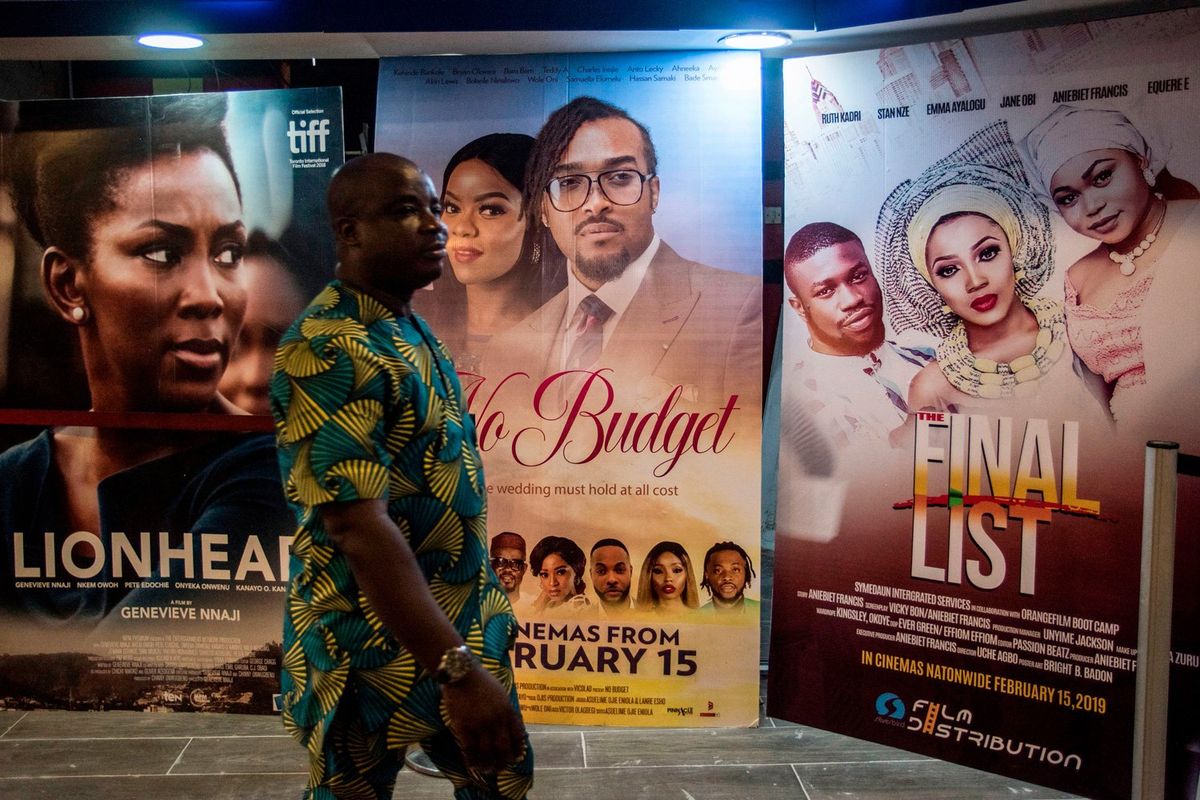 A man passes by Nigerian movie billboards at a cinema in Lagos on February 19, 2019.