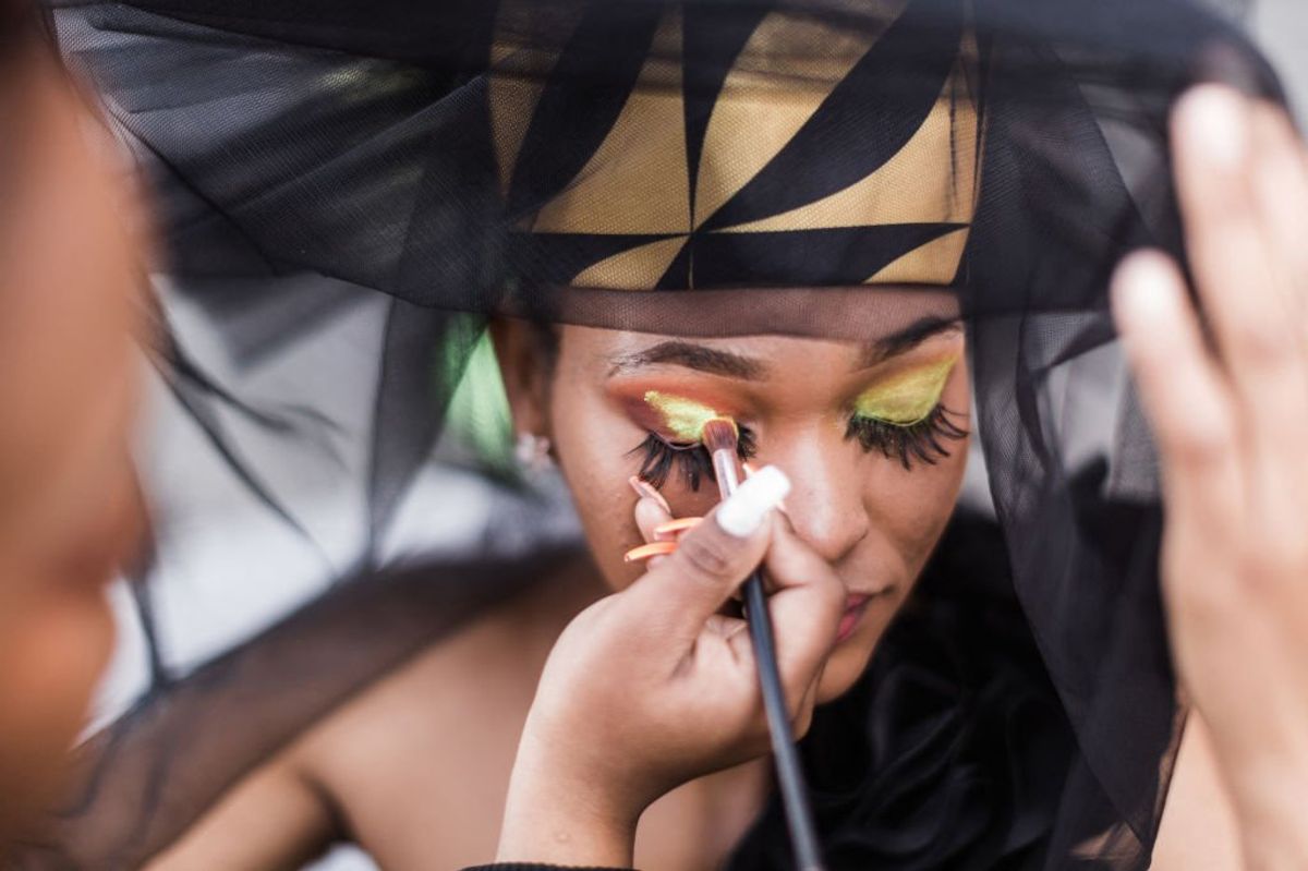 A model gets her make up done during a fashion show at the 2022 editon of the Durban July horse race in Durban on July 2, 2022.