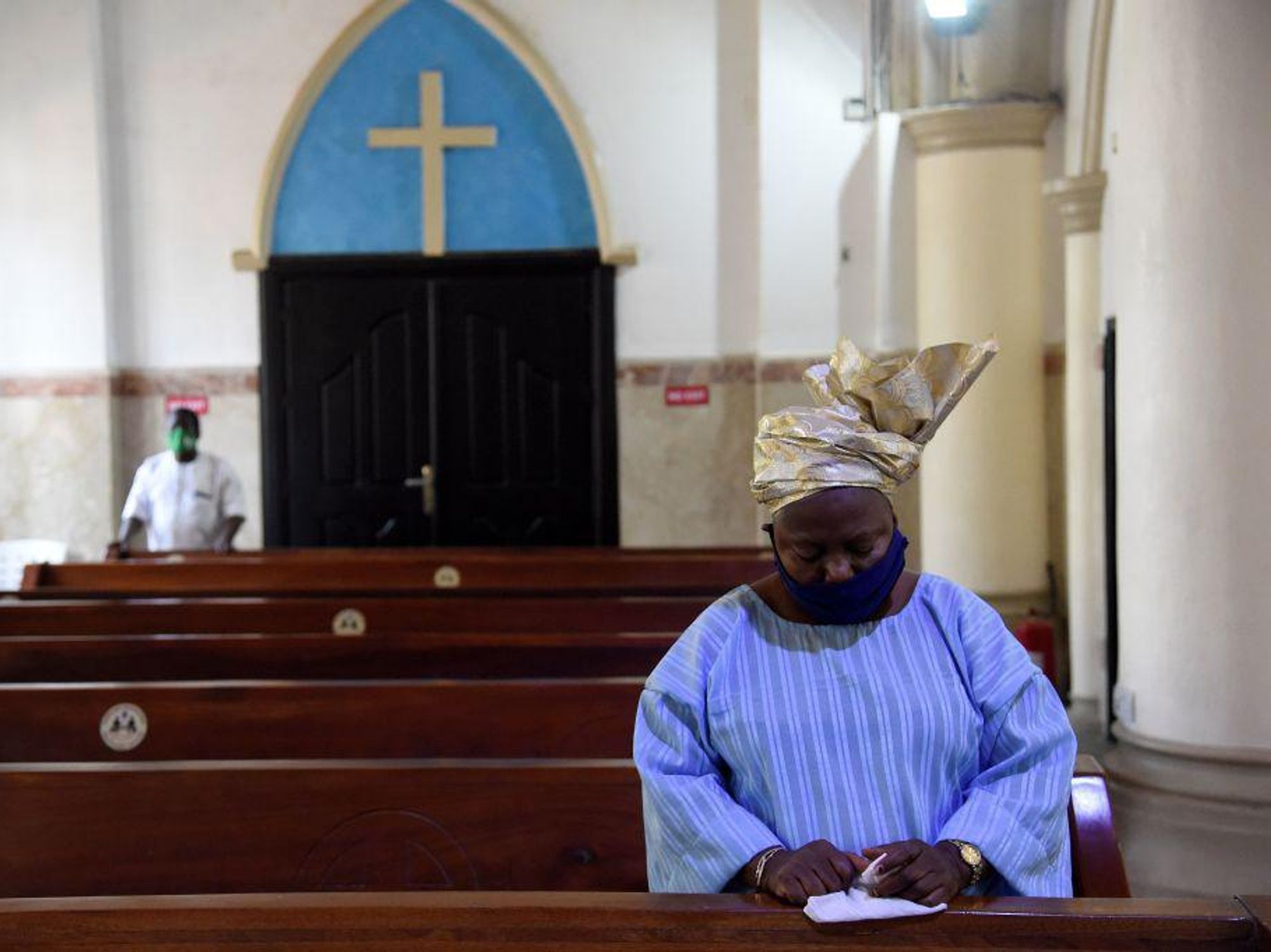 A Nigerian woman prays in a catholic church 