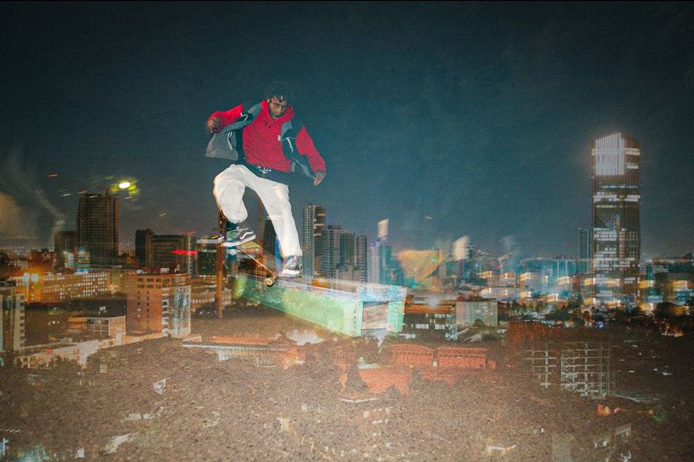 A photo illustration of a skateboarder imposed over a city skyline.