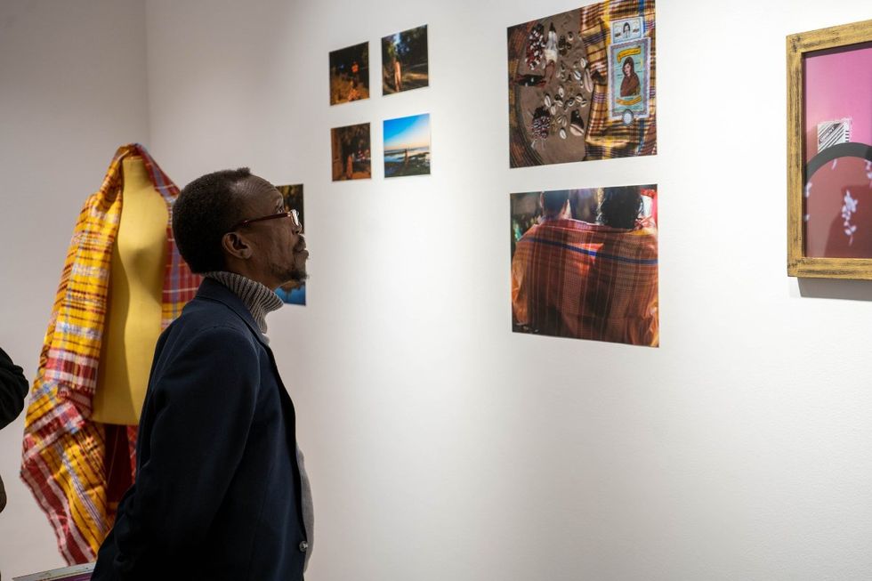A photo of a guest looking at an artwork hung on the wall during an exhibition at the Goethe-Institut in Cairo.