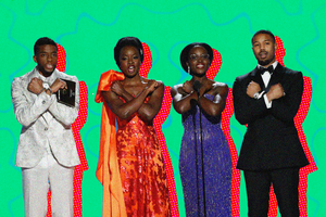 A photo of Chadwick Boseman, Danai Gurira, Lupita Nyong'o and Michael B. Jordan doing the 'Wakanda Forever' sign - arms crossed in front of the chest.