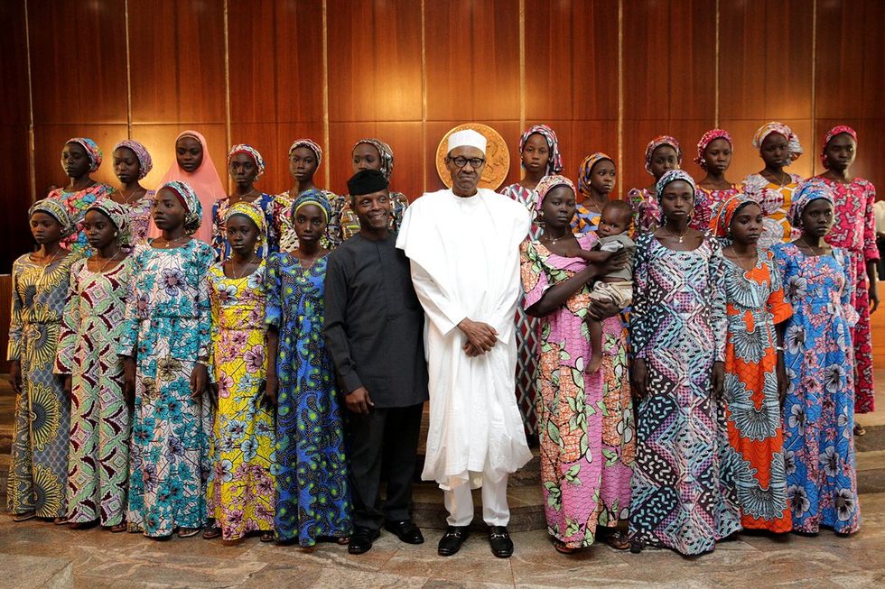 A photo of President Muhammadu Buhari and Vice President Yemi Osinbajo with the 21 Chibok schoolgirls released in 2016.