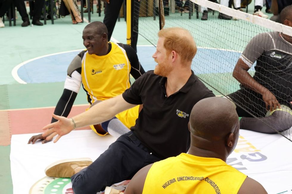 A photo of Prince Harry playing sitting volleyball.