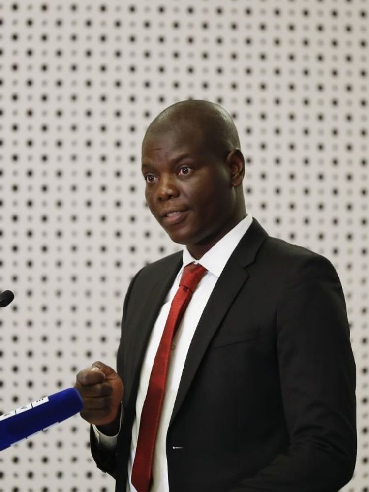 A photo of South Africa’s Minister of Justice Ronald Lamola speaking at an event. 