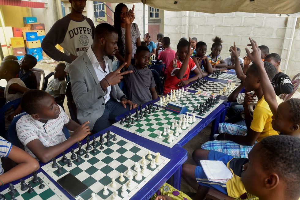 A photo of Tunde Onakoya addressing children during a chess class at Ogolonto in Ikorodu district of Lagos on August 17, 2019.
