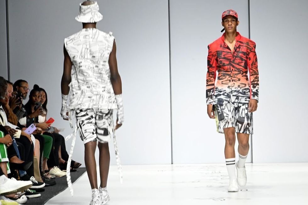 A photo of two models on the runway during the Loxion Kulca show at South African Fashion Week in 2022.