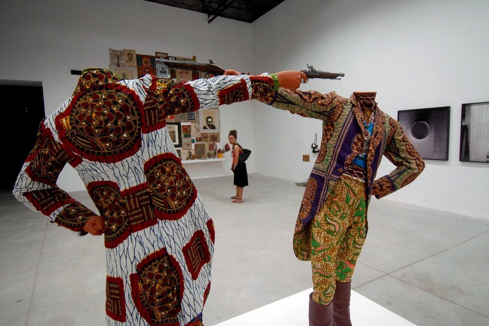 A photo of Yinka Shonibare MBE\u2019s installation \u201cHow to blow up two heads at once\u201d at the 2007 Venice Biennale.