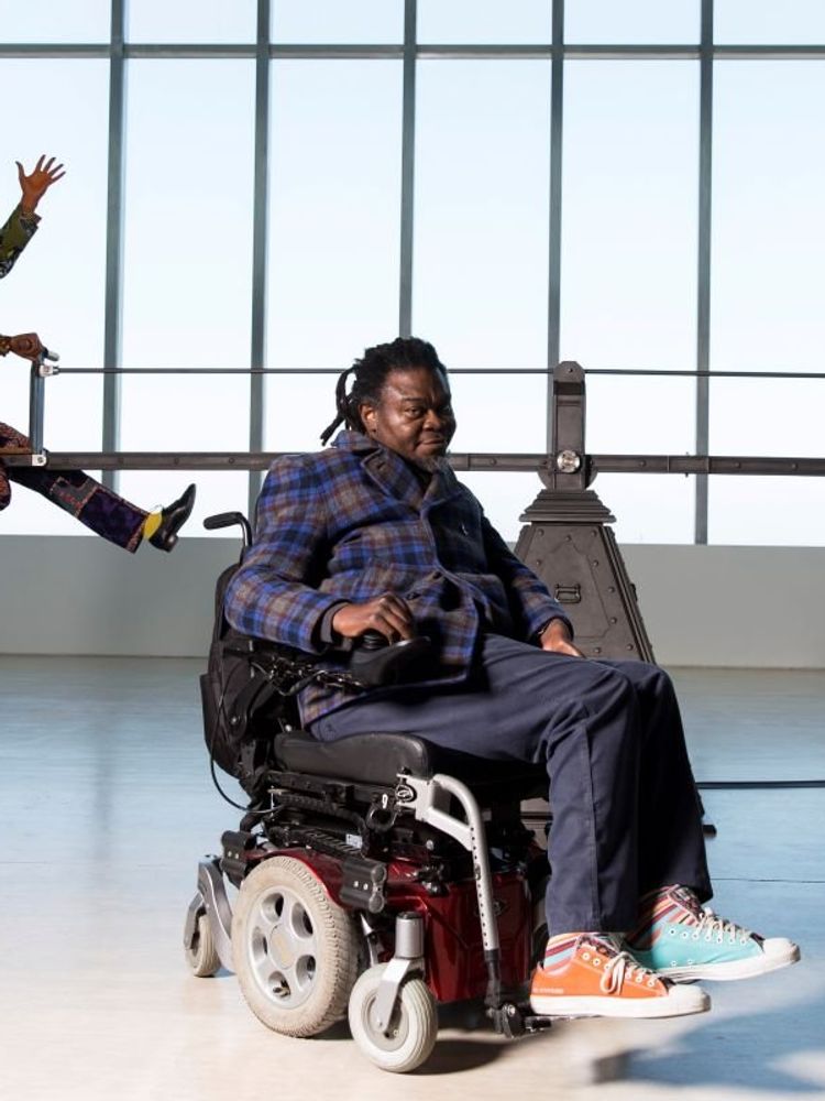A photo of Yinka Shonibare MBE with his work “End of Empire” at Turner Contemporary as part of the 14-18 NOW programme.