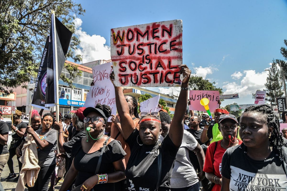 A protester marches while holding a placard during the demonstration. Protesters marched countrywide during the 'Feminists March Against Femicide,' which was sparked by the recent brutal murders of Starlet Wahu, 26, and Rita Waeni, 20, in Kenya.