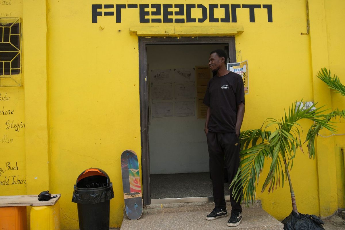 A skateboarder stands at the entrance of a room at the freedom skatepark in Accra