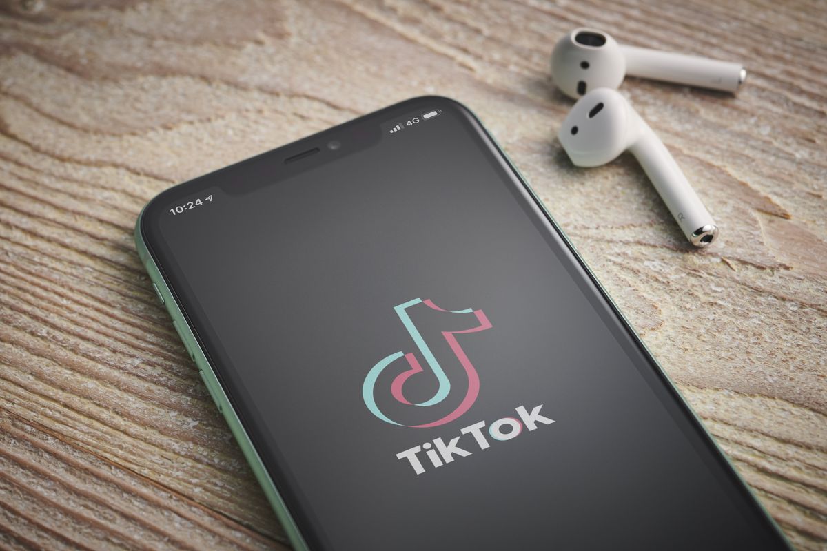 A smartphone with the TikTok video sharing app logo on screen