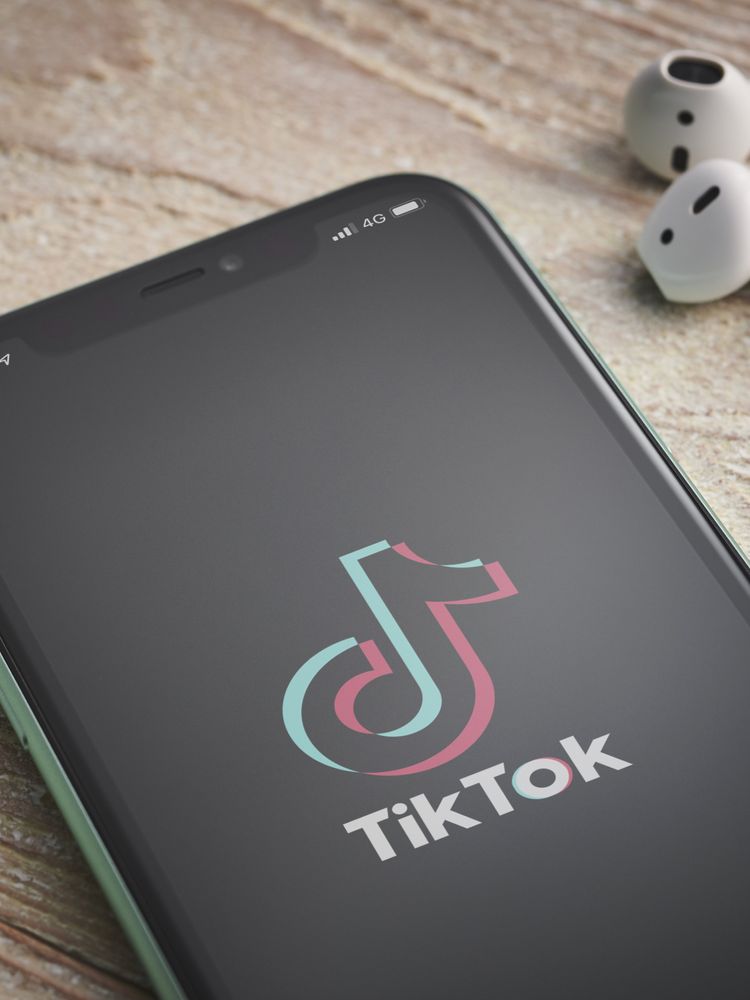 A smartphone with the TikTok video sharing app logo on screen