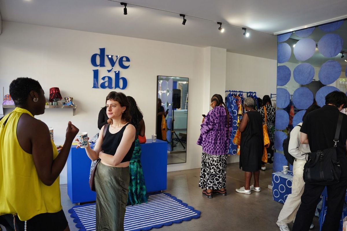 A snapshot of a clothing store filled with shoppers talking to each other and looking around.