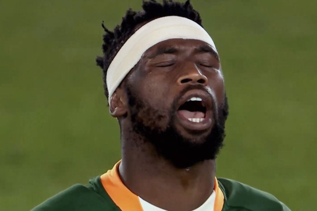 A still from the documentary of Siya Kolisi with his eyes closed, looking up with his mouth open wide. 