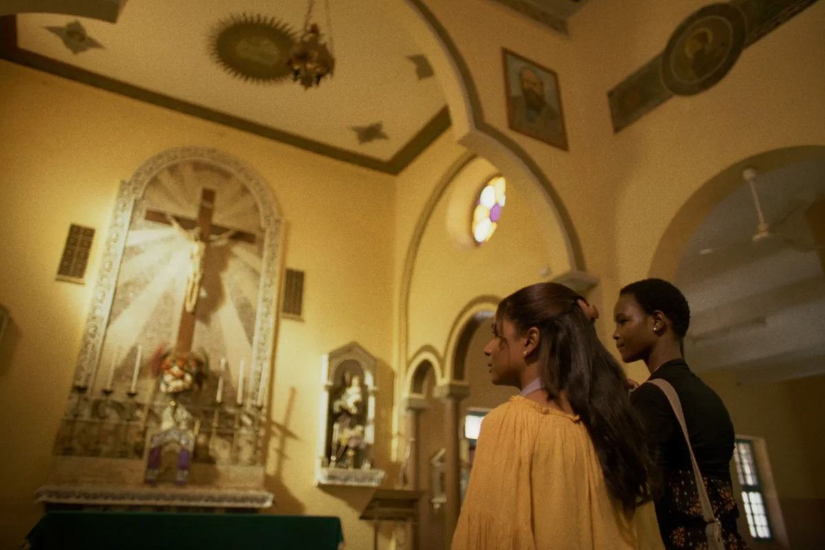 A still from the film, 'Goodbye Julia,' of two women inside a church. ​