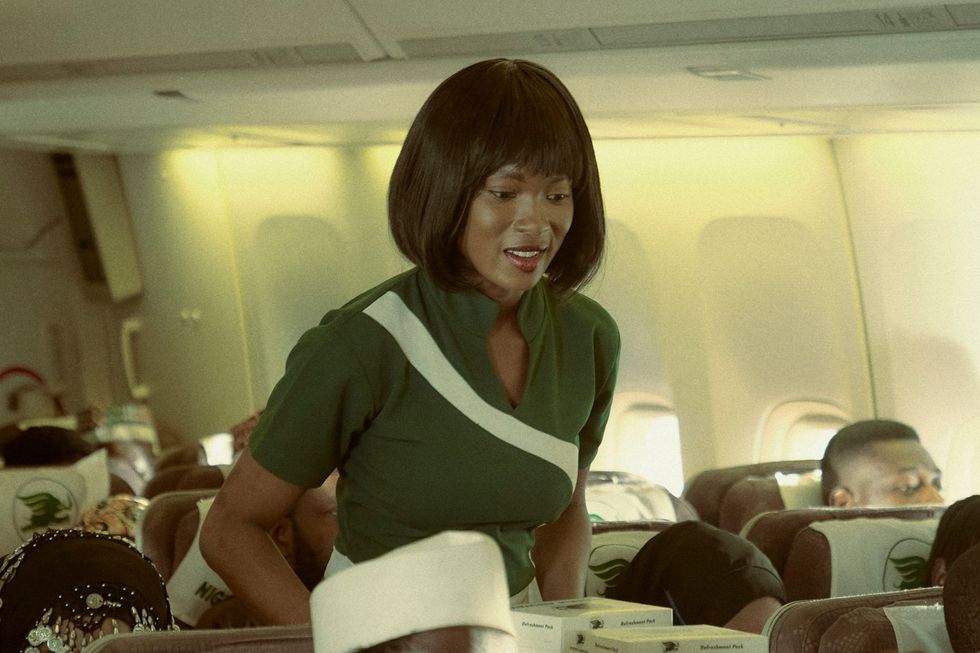 A still from the forthcoming Play Network film, 'Hijak 63,' of a woman cabin attendant pushing a trolley through an airplane.
