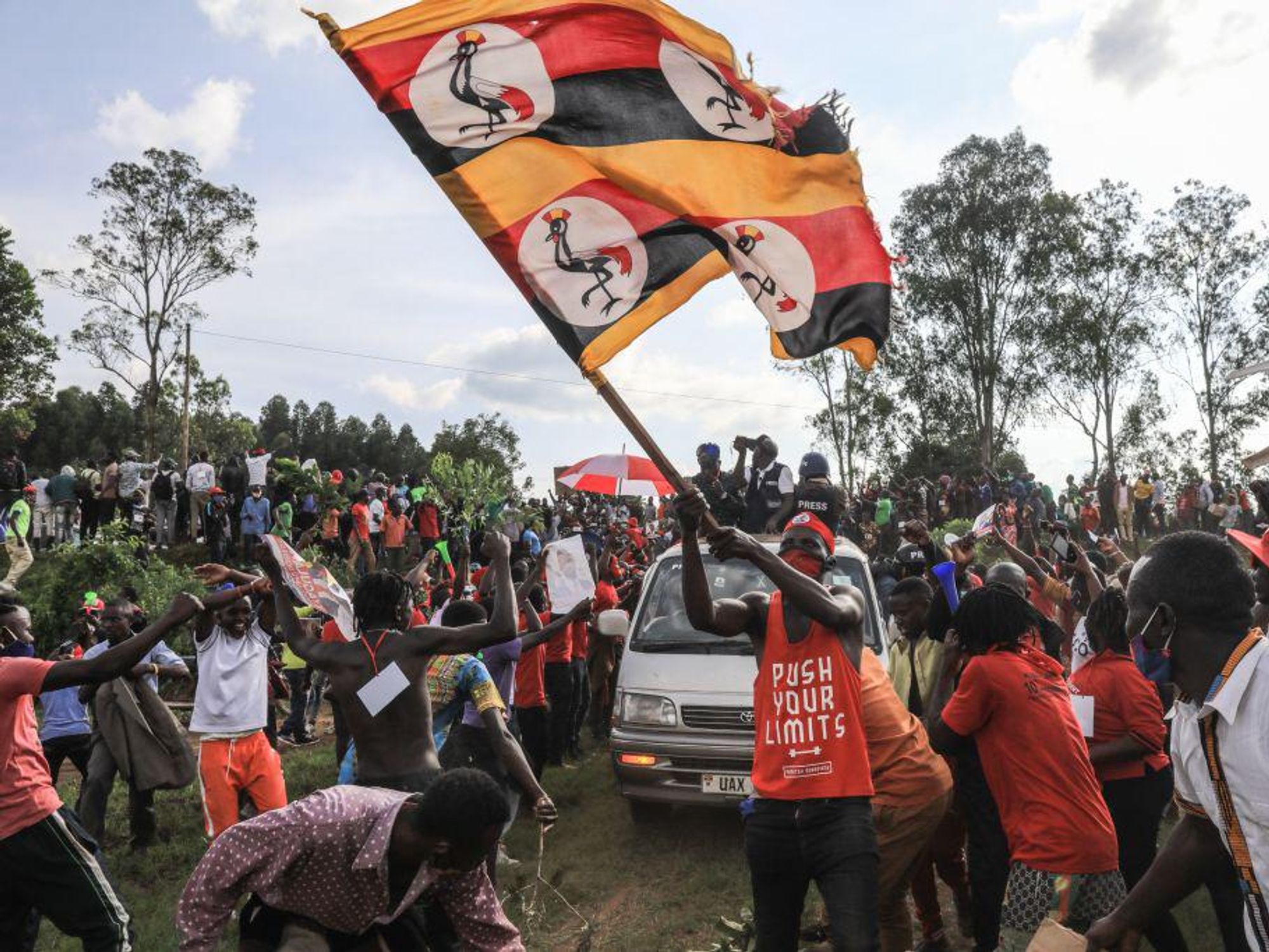 A supporter of Ugandan musician turned politician Bobi Wine, waves Ugandan flag during his presidential rally in Fort Portal on November 23, 2020.