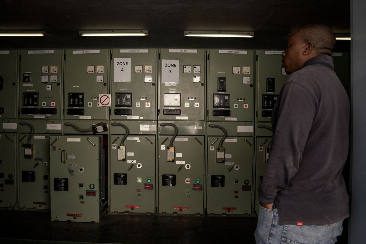 A worker stands at the entrance of private electricity distributor Rural Free State's substation in Frankfort, Free State, South Africa on May 9, 2023.