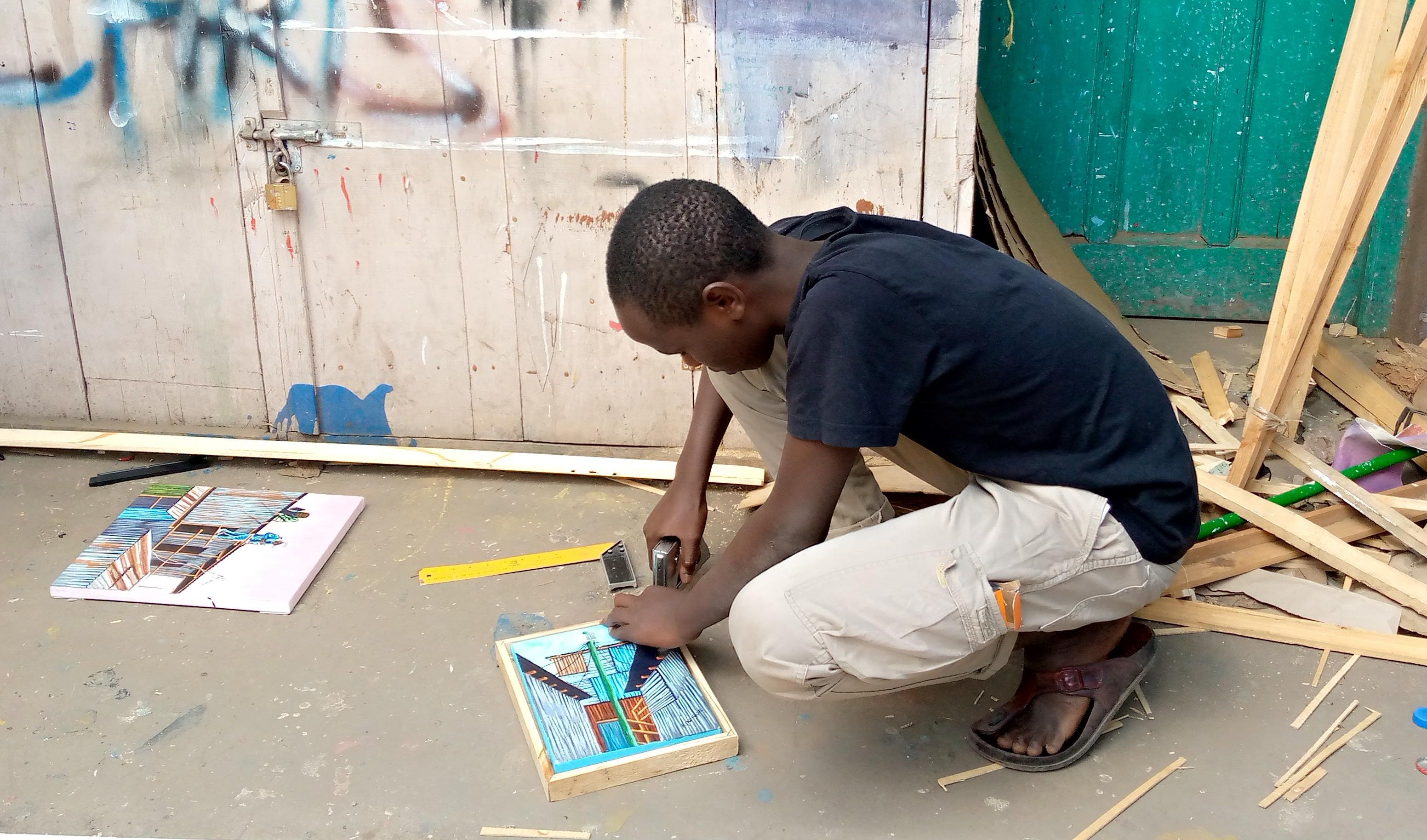 A young man working on a painting