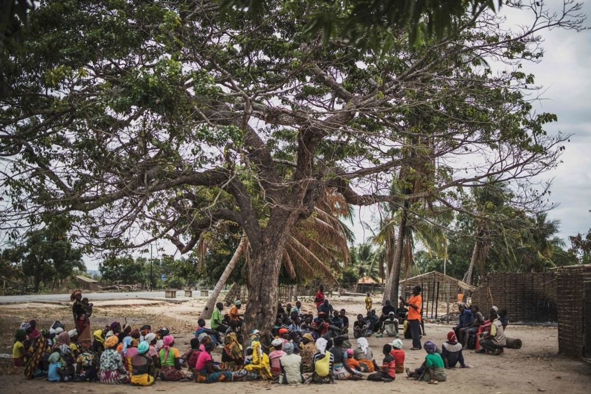 African people gathered under a tree