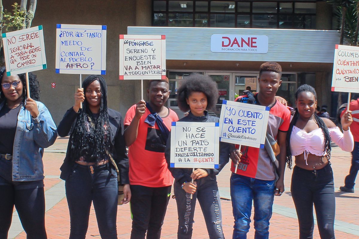Afro-Colombian, Black, Raizal, and Palenquero civil-rights activists holding signs protesting the Colombian census' erasure of Afro-descendants.