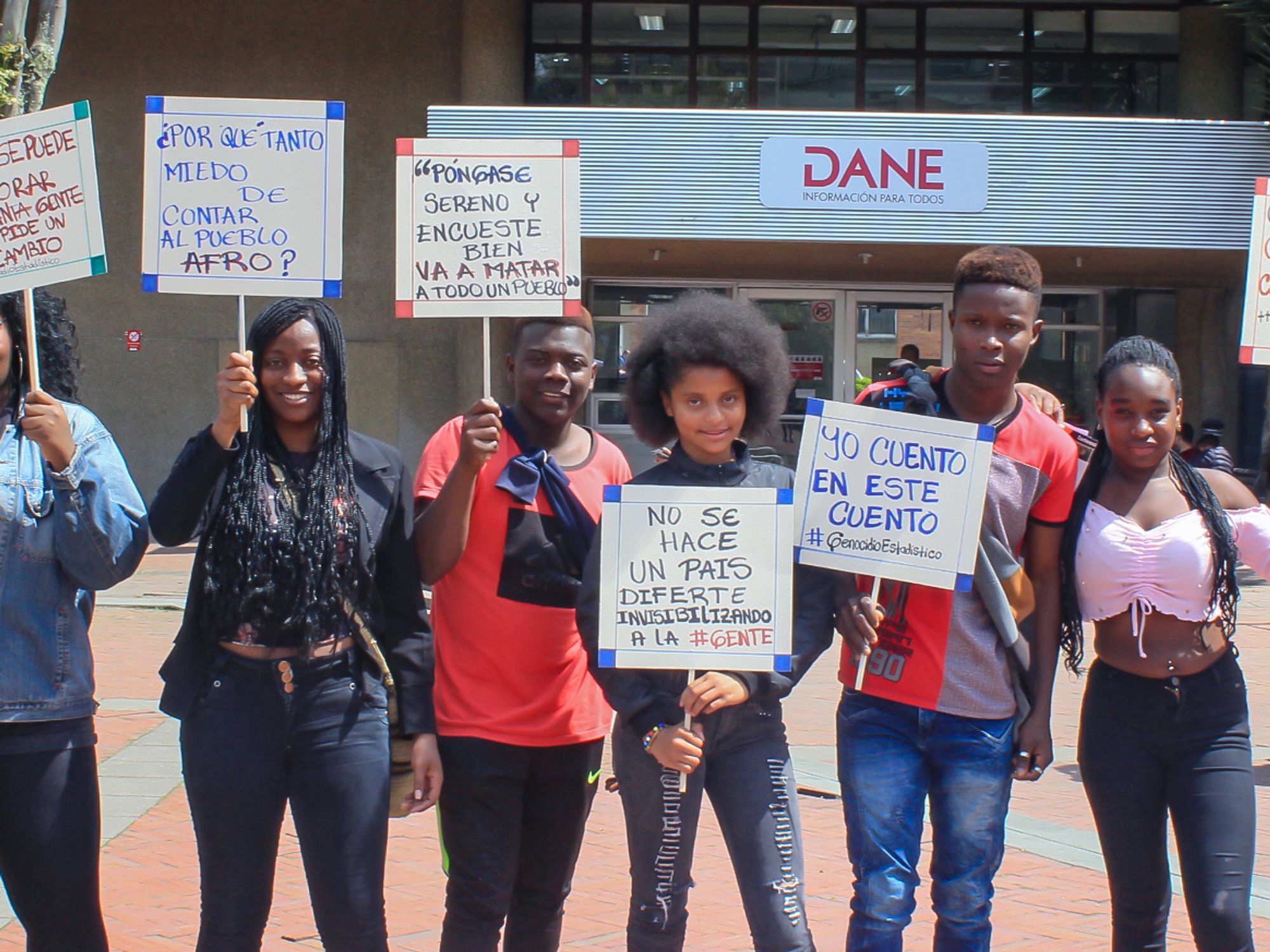 Afro-Colombian, Black, Raizal, and Palenquero civil-rights activists holding signs protesting the Colombian census' erasure of Afro-descendants.