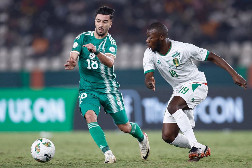 Algeria's forward #18 Mohamed Amoura fights for the ball with Mauritania's forward #19 Aboubakary Koita during the Africa Cup of Nations (CAN) 2024 group D football match between Mauritania and Algeria at Stade de la Paix in Bouake on January 23, 2024.