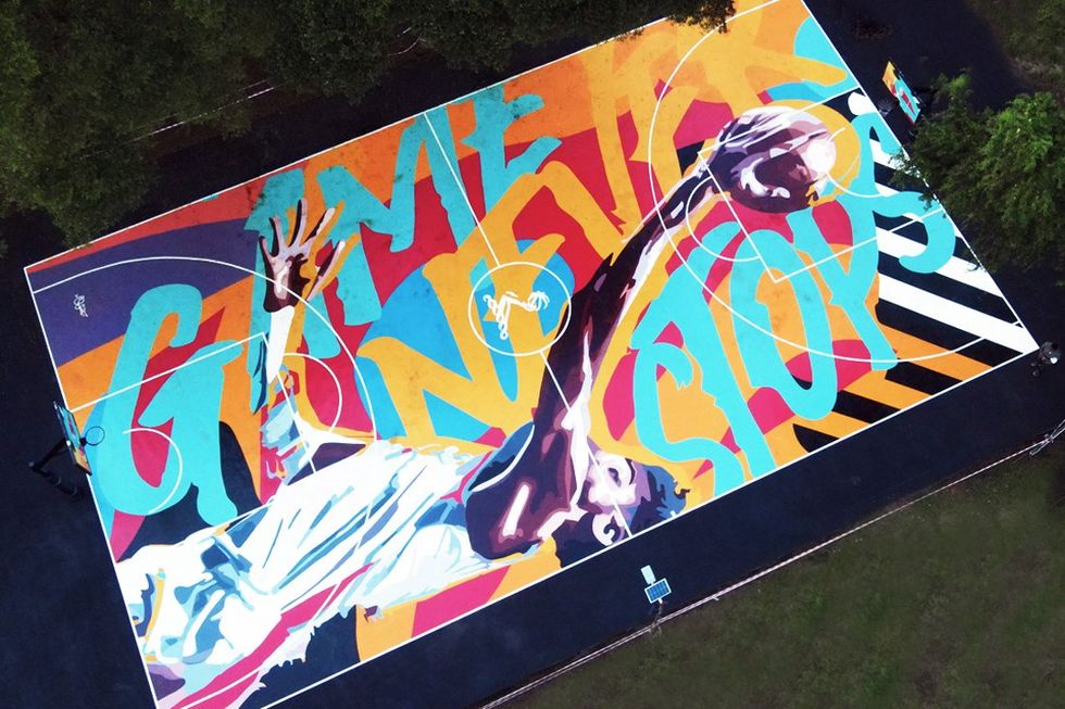 An aerial view of a Osa Seven\u2019s graffiti mural on a basketball court in Victoria Island, Lagos.