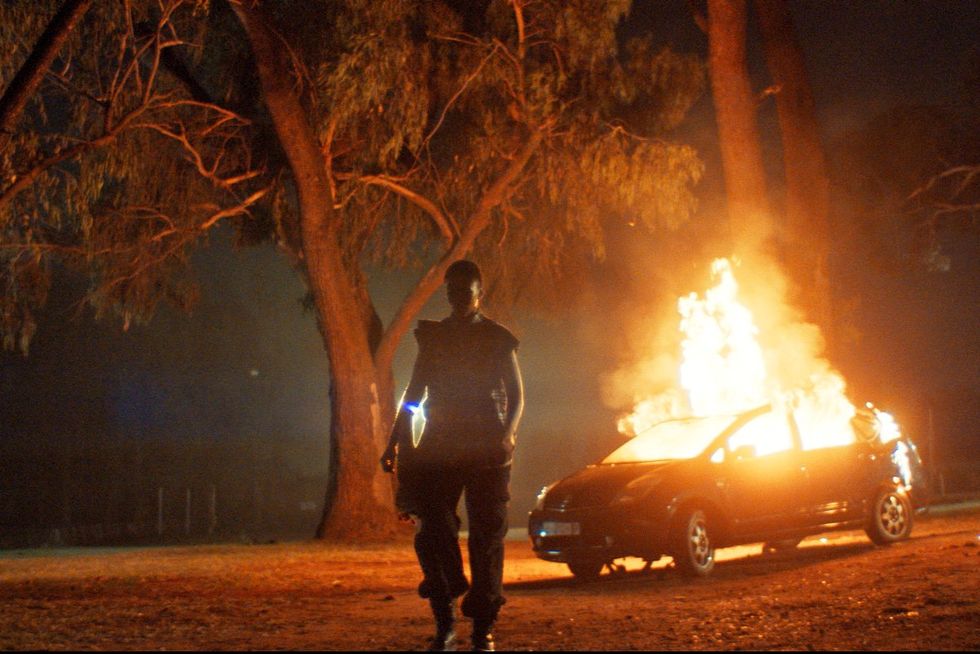 An image from the film of a car on fire. 