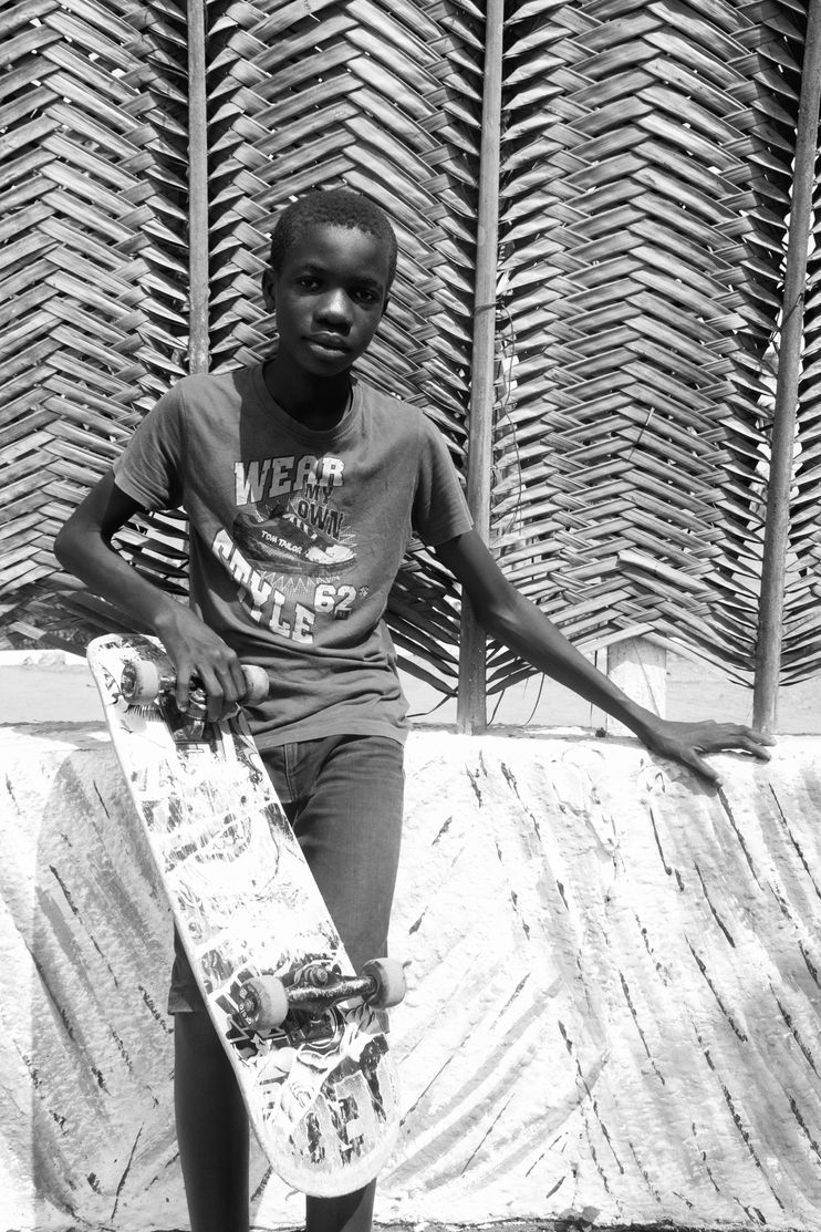 An image of a young boy holding a skateboard