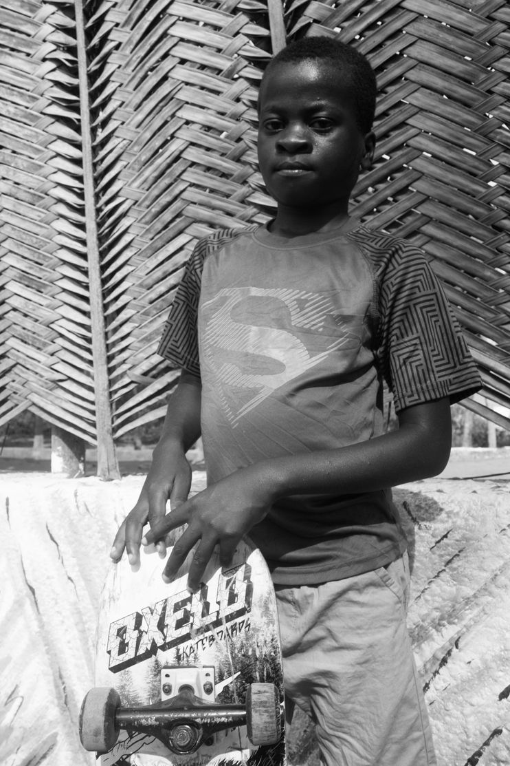 An image of a young boy with a skateboard