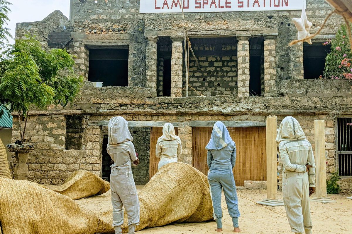An image of artists standing in front of the Lamu Space Station art gallery in Kenya