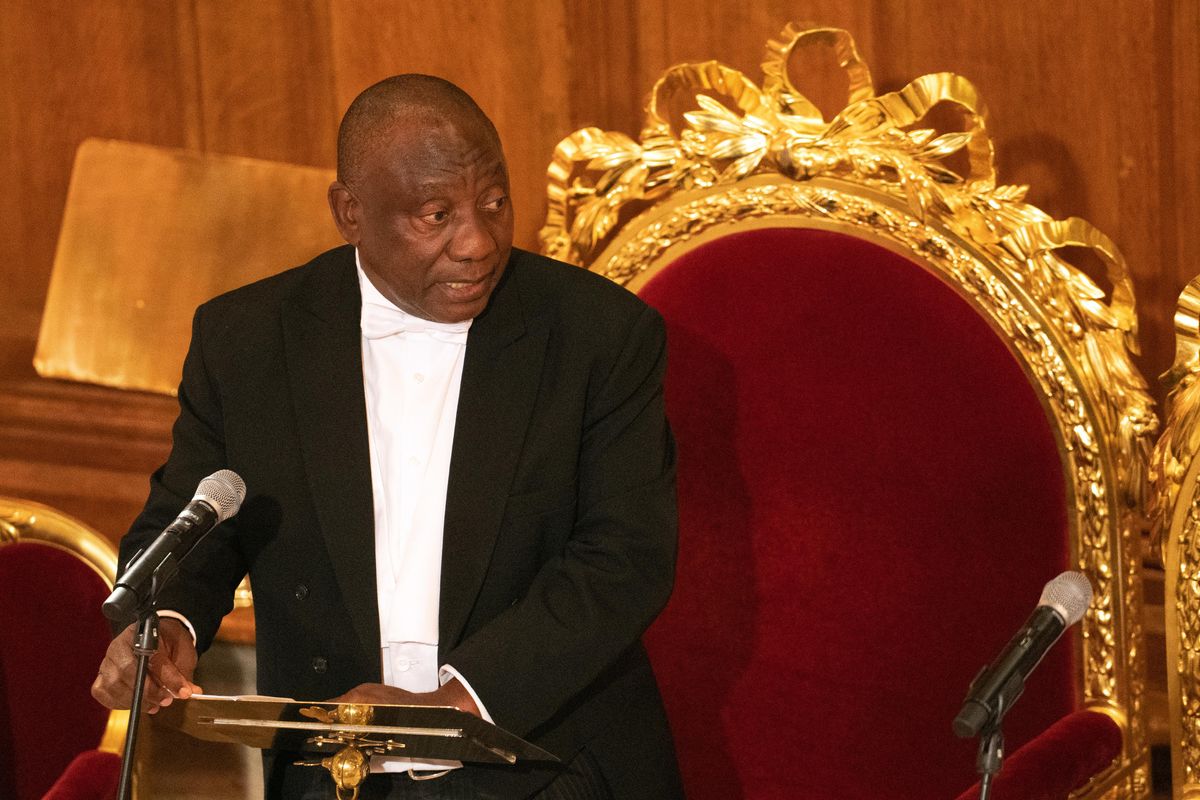 An image of Cyril Ramaphosa standing at a lectern 