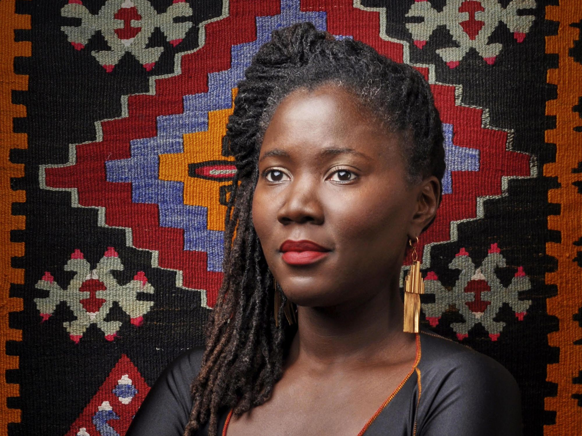An image of filmmaker Alice Diop looking off to the side. 