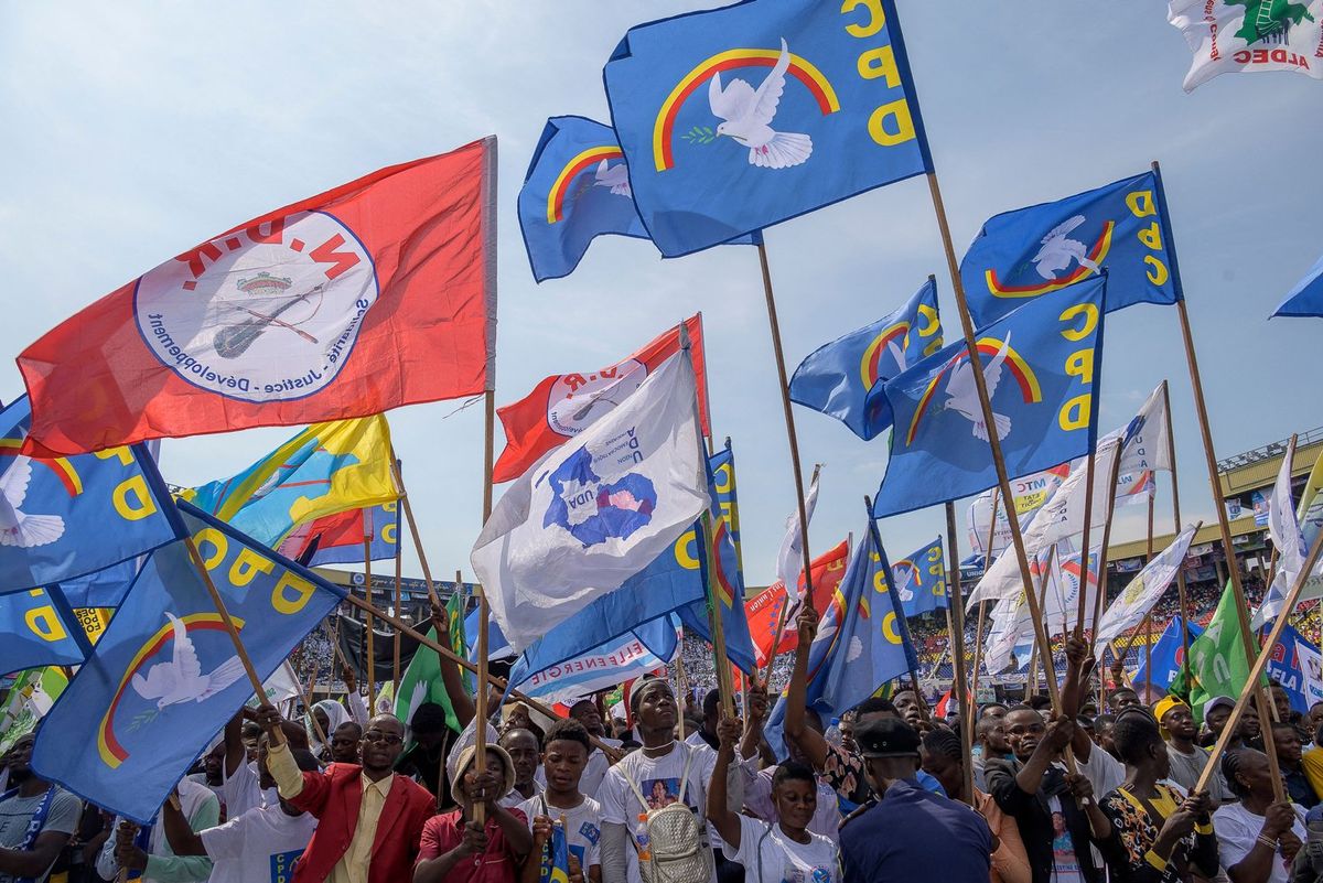 An image of flags of a political party in the DRC waving in the air. 