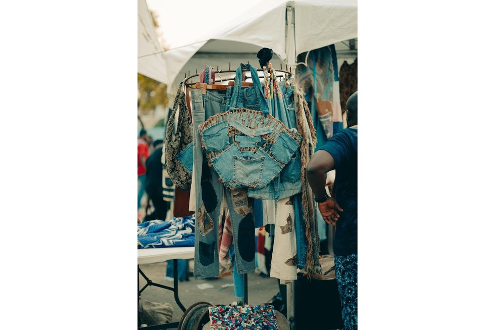 An image of refashioned denim items hanging on a hanger.