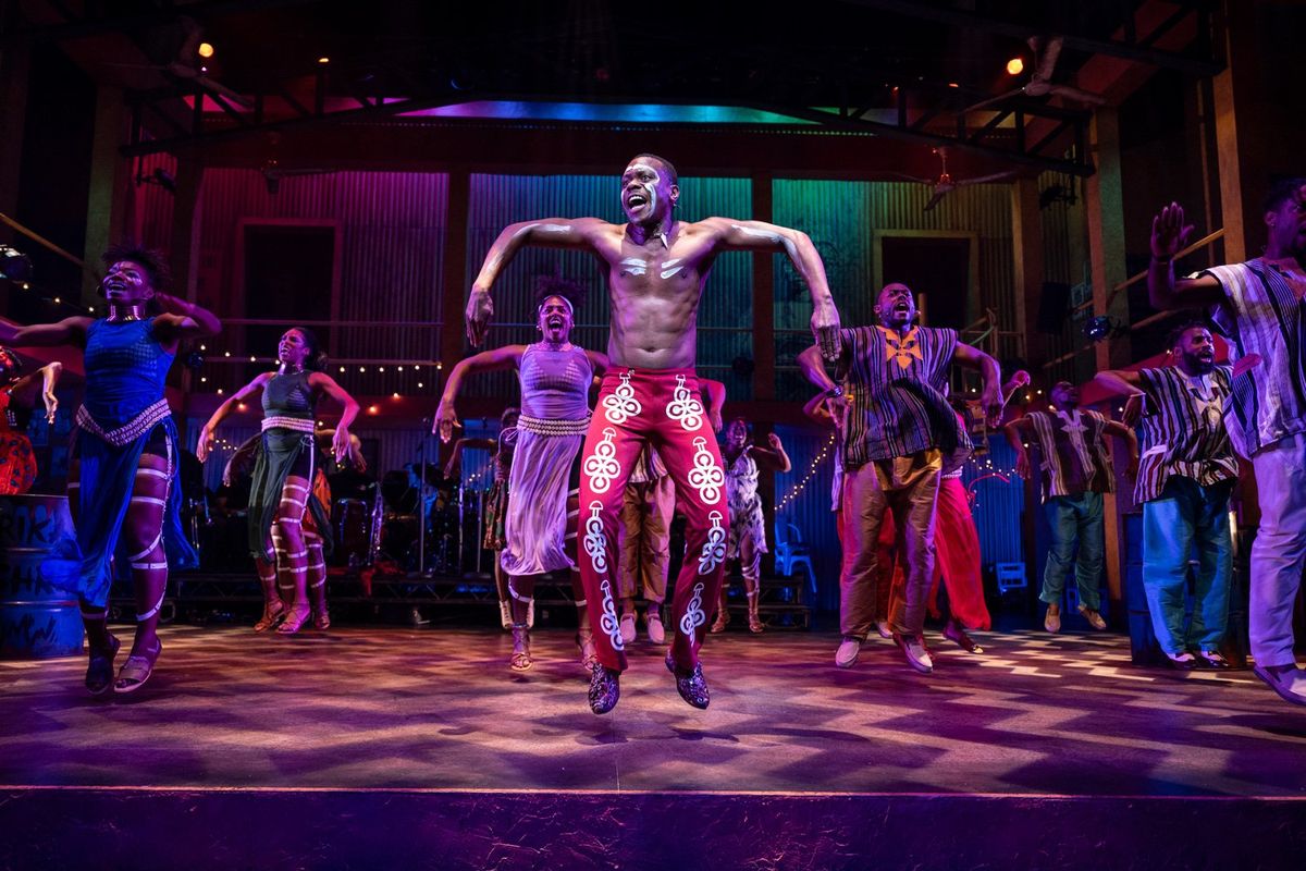 An image of the actor Duain Richmond jumping on stage as Fela. 