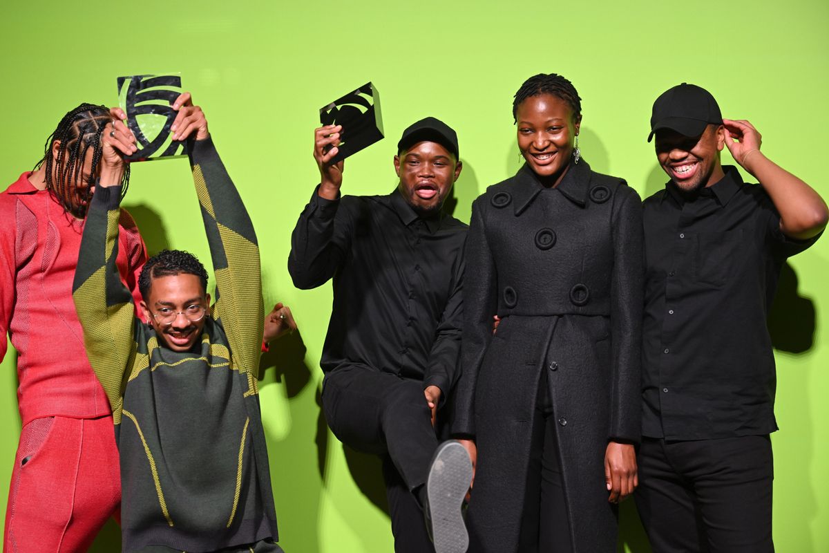 An image of the designers Saul Nash and Mmuso Potsane and Maxwell Boko, standing against a green background, smiling