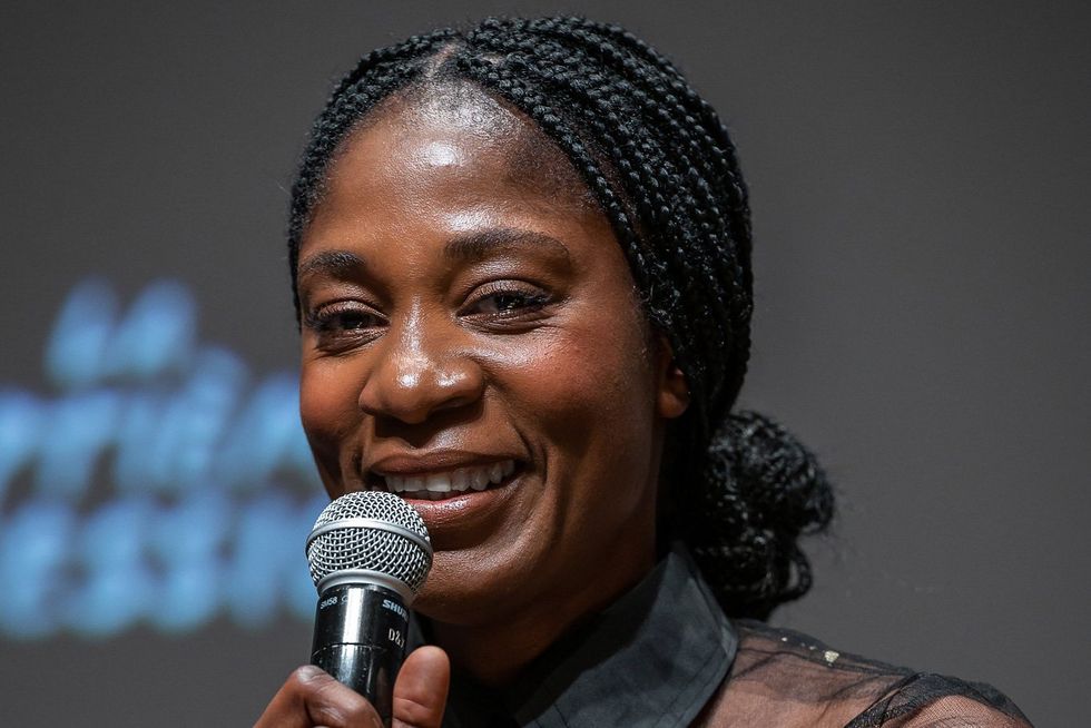 An image of the filmmaker, Rosine Mabakam, holding a microphone.