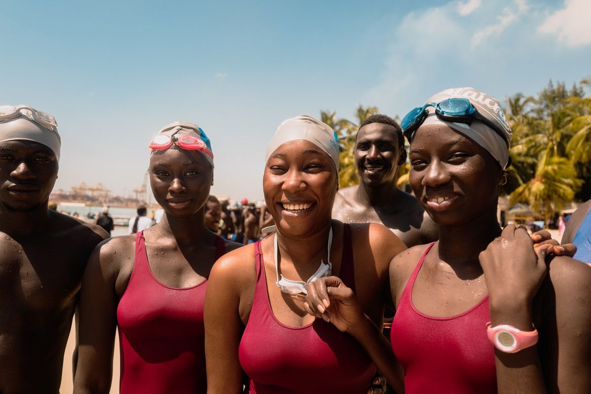An image of the Swim Dem Crew women standing ready to go swimming.